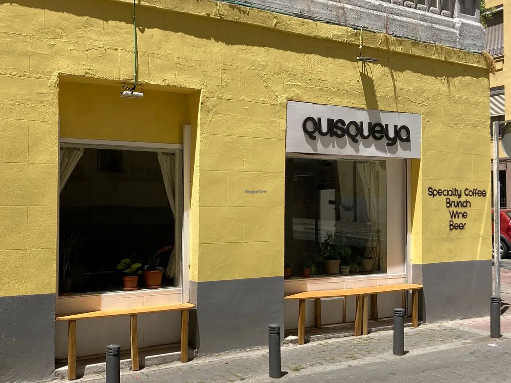 bright yellow storefront with "busqueya" signage offering specialty coffee, brunch, wine, and beer., quisqueya, madrid