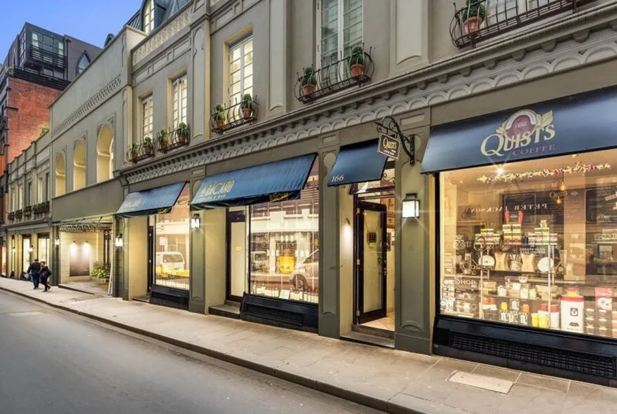 historic storefront with blue awnings displaying luxury retail shops on elegant street., quists coffee, melbourne
