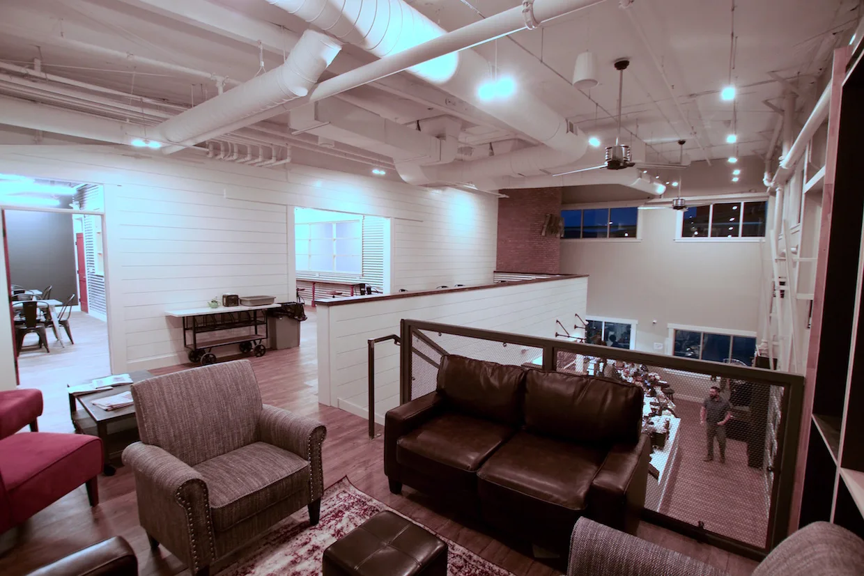 modern open-plan office lounge with leather furniture and white shiplap walls., red silo coffee roasters, arvada
