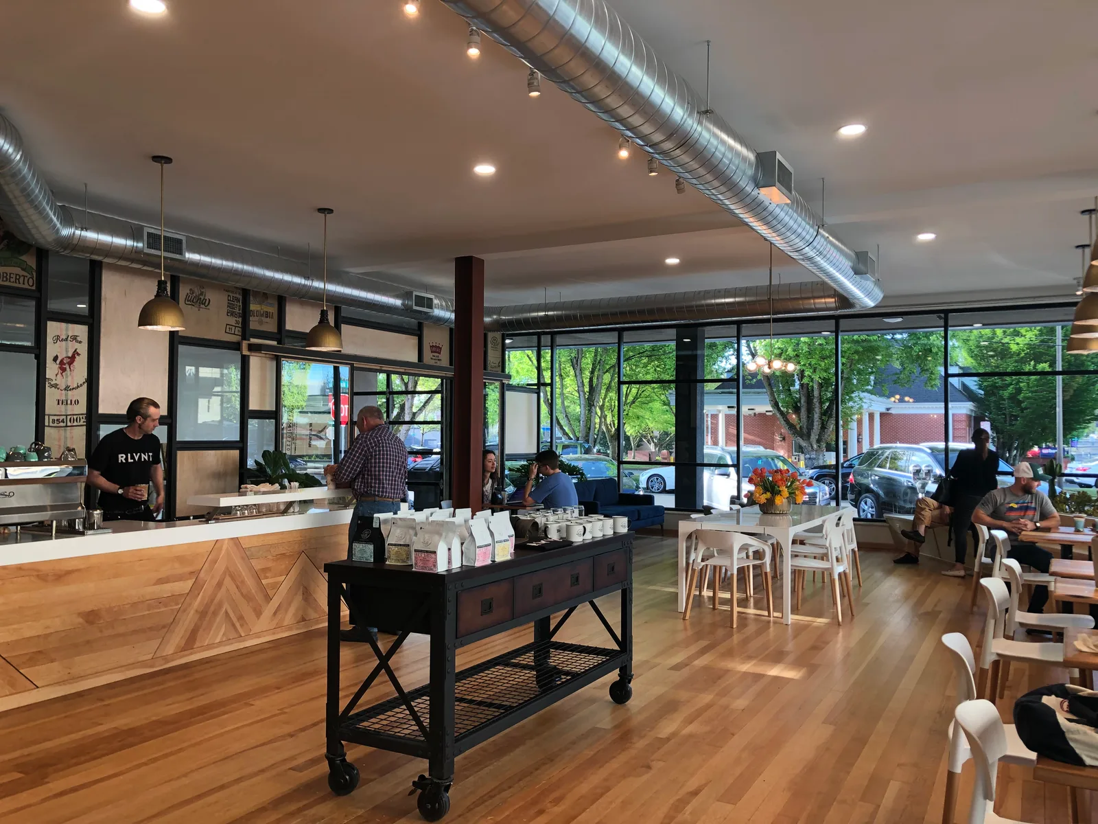 modern coffee shop interior with counter, seating, large windows, and industrial ceiling ducts., relevant coffee, vancouver