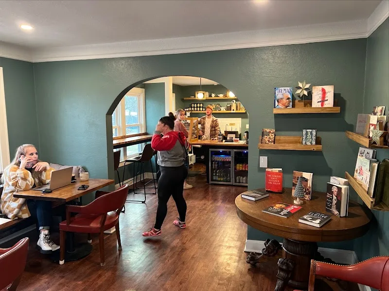 cozy interior bookstore or café with teal walls, wooden shelves, and customers browsing., renegade coffee, kansas city