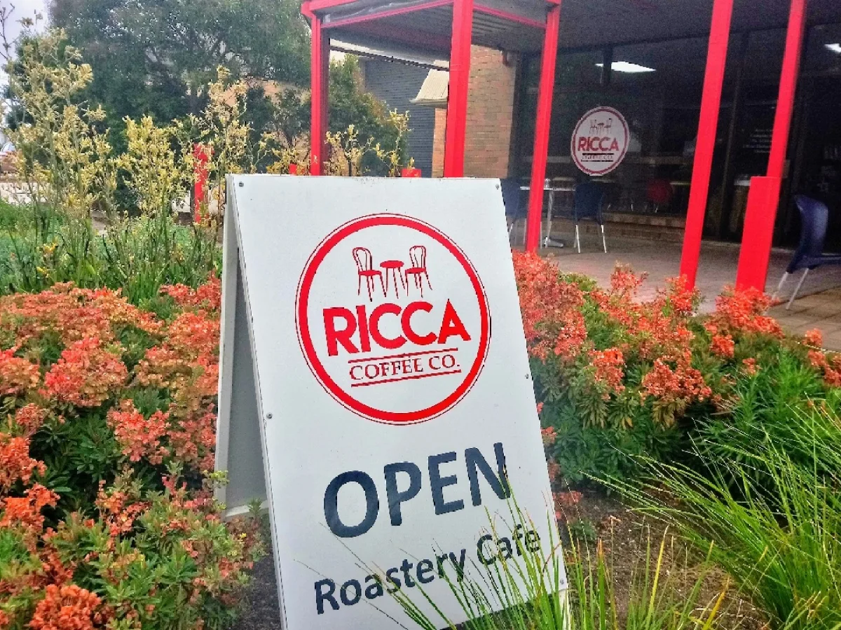 ricca coffee co. storefront with open sign, red flowers, and modern architecture., ricca coffee company, thebarton