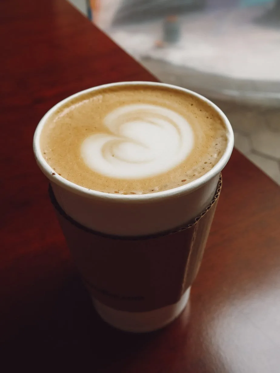 layered coffee drink with latte art swirl in takeaway cup., ristretto - arequipa, arequipa
