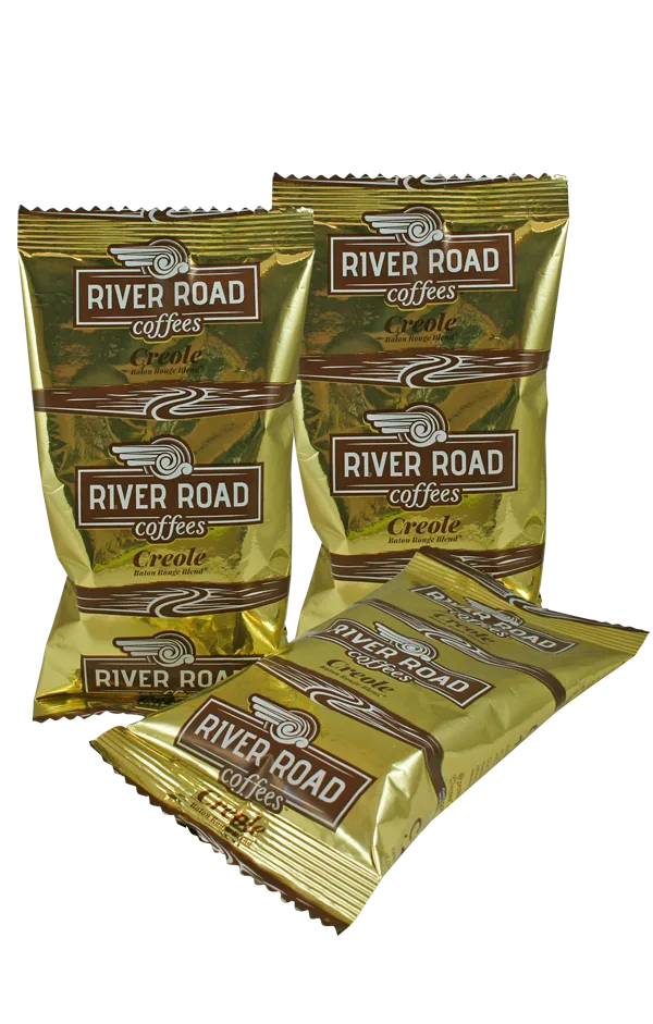 river road creole coffee packets in gold foil packaging, various sizes displayed together., river road coffees, baton rouge