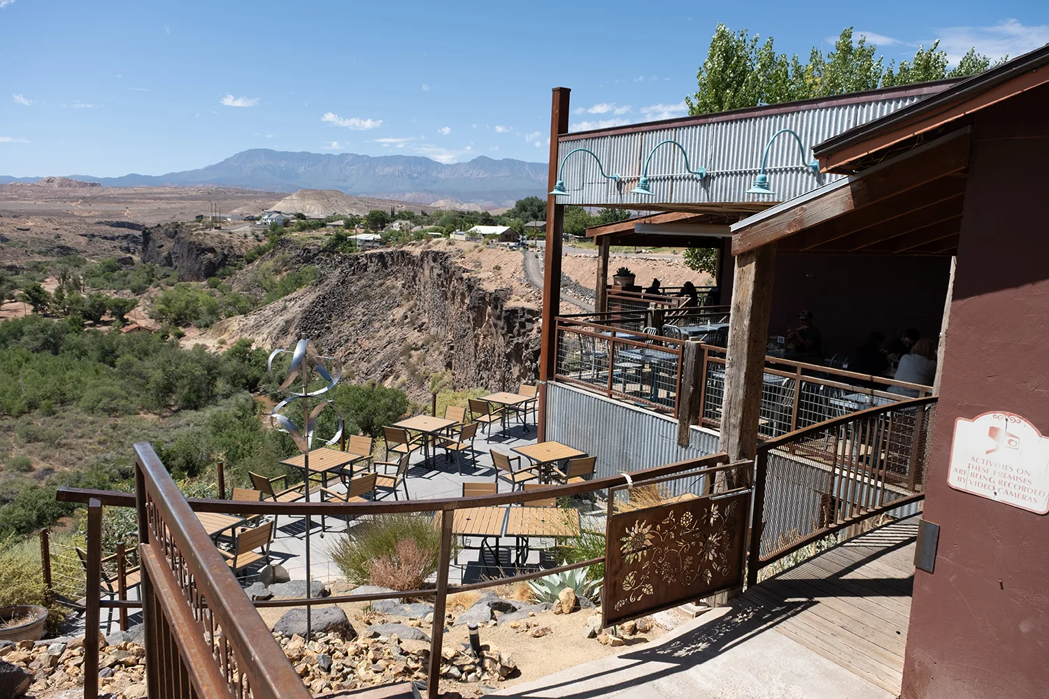 rustic desert venue with tiered decks overlooking canyon and mountains., river rock roasting company, utah