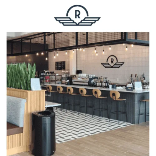 modern café interior with black counter, wooden stools, pendant lights, and geometric flooring., rivet coffee bar and roaster