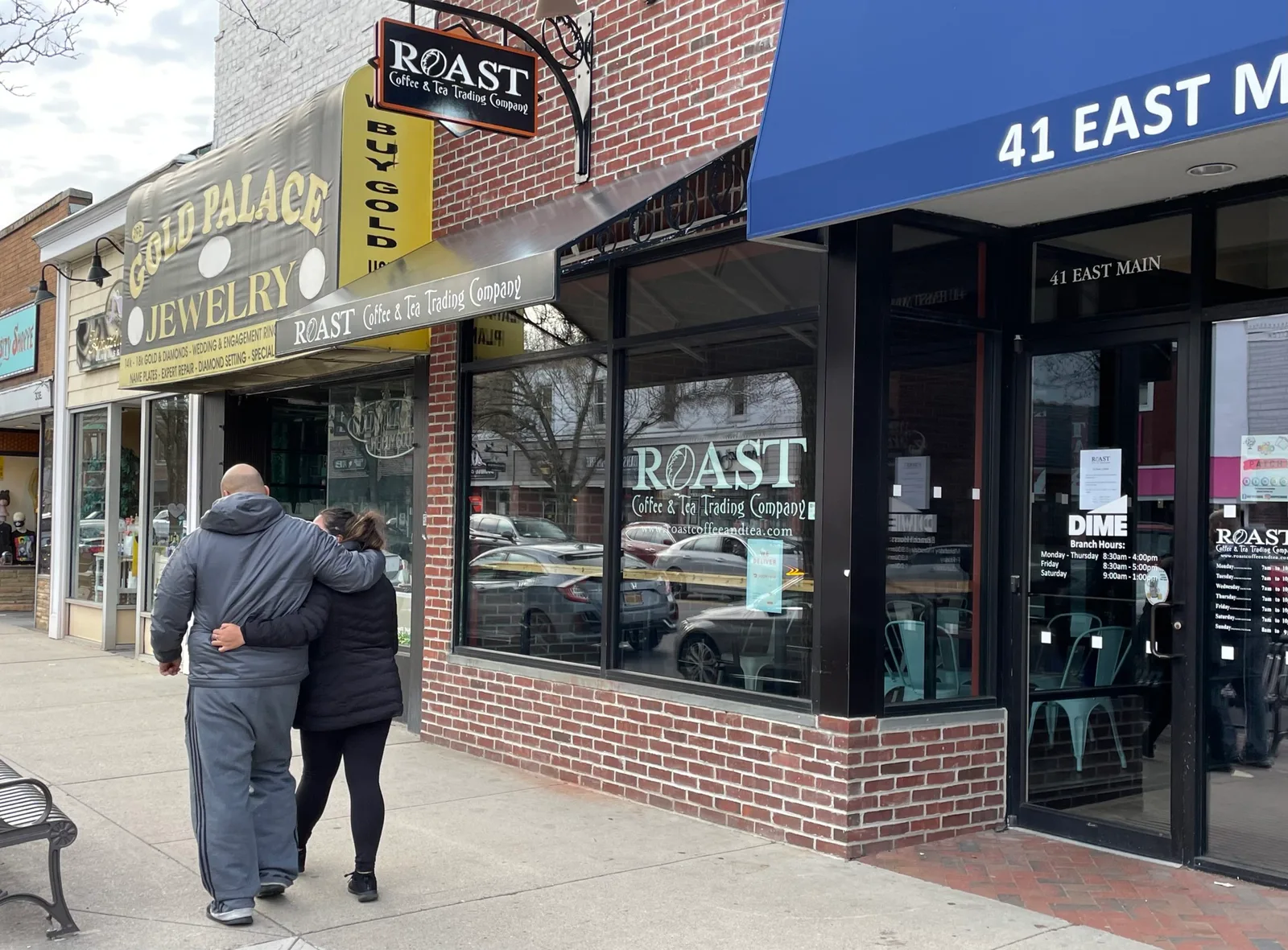 street scene with storefronts including gold palace jewelry and roast coffee tea trading company., roast coffee & tea trading