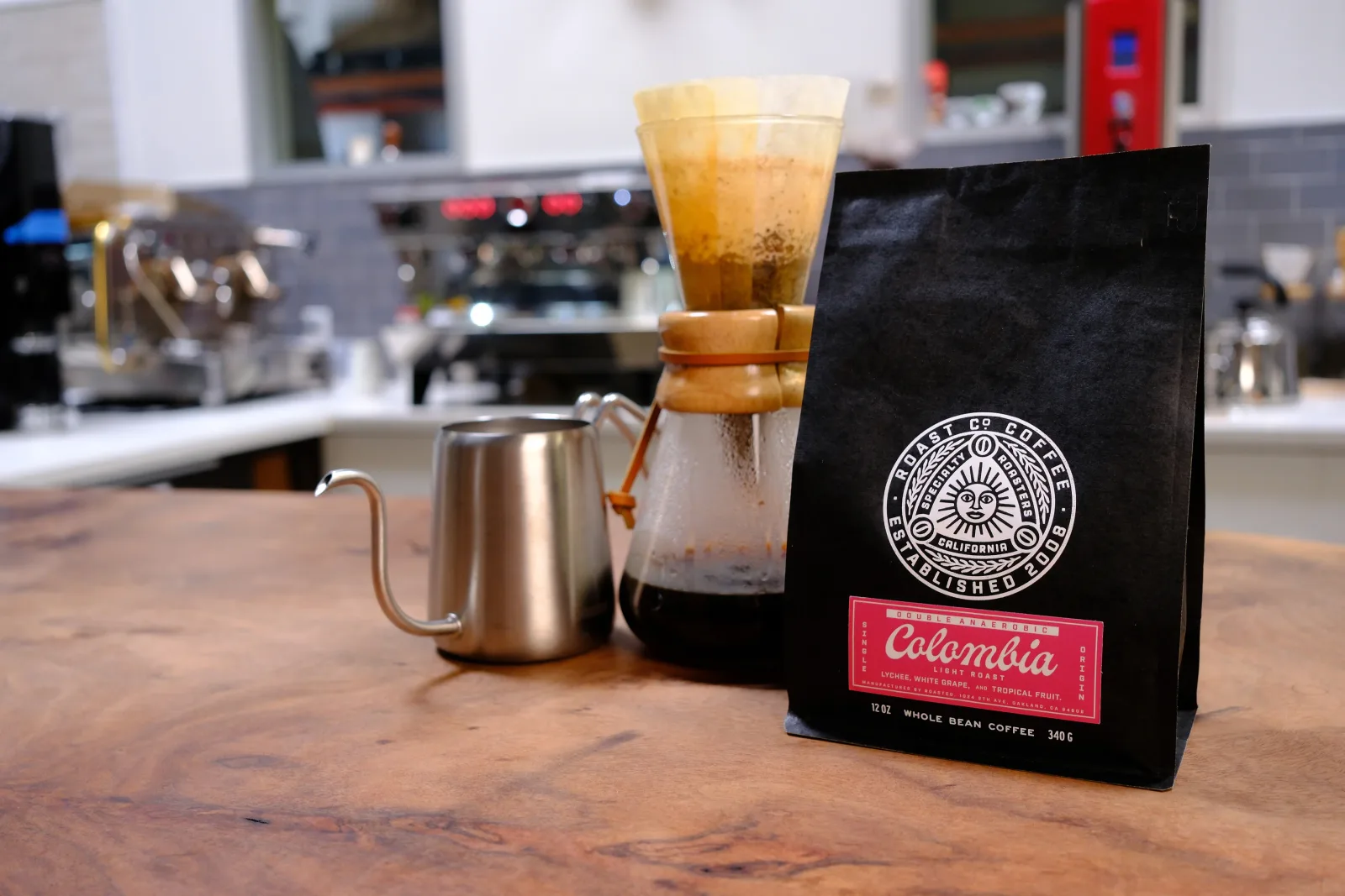 colombia whole bean coffee bag with pour-over brewing setup and iced beverage., roastco, san francisco