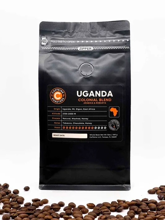 uganda colonial blend coffee bag surrounded by scattered roasted coffee beans., roasted!, tampa