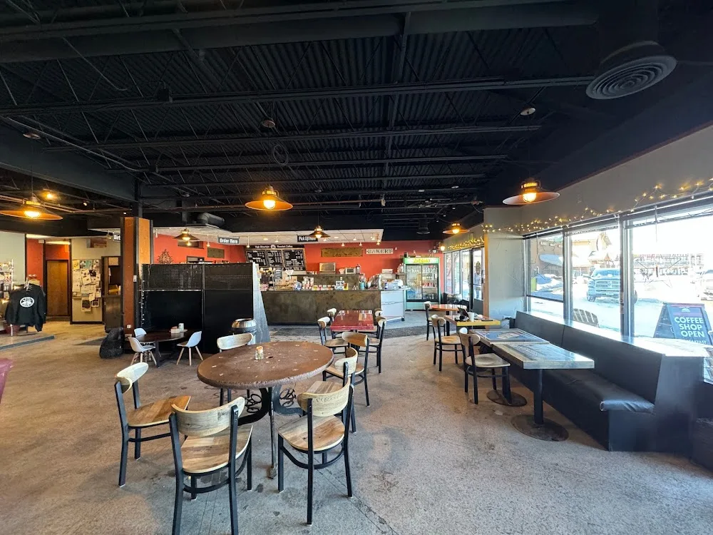 modern casual restaurant interior with round tables, orange accent wall, and counter seating., rocky mountain roastery cafe, 