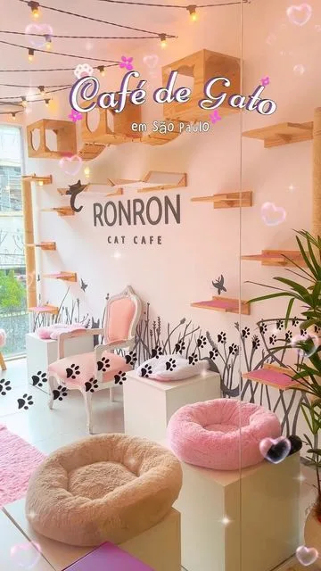 cat cafe interior with pink and beige decor, climbing shelves, and cushioned seating areas., ronron cat café, são paulo