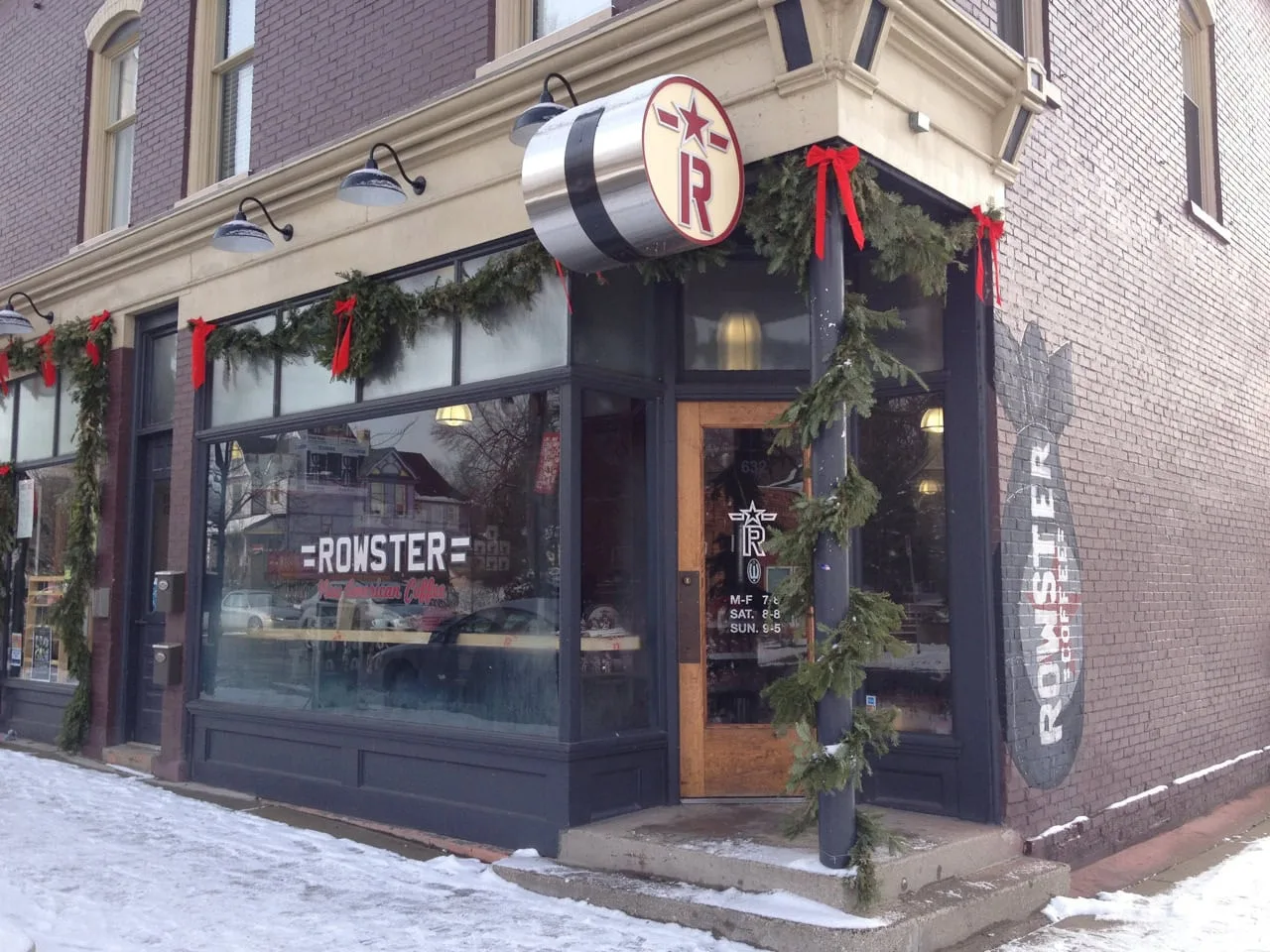 corner storefront decorated for holidays with garland and red bows., rowster new american coffee, michigan