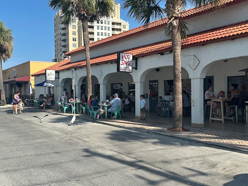 spanish colonial architecture restaurant with outdoor seating and palm trees., ryan's island cafe, clearwater