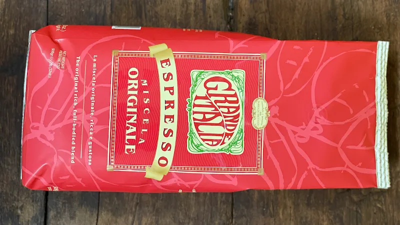 red pasta box with gold lettering and decorative design on wooden surface., sacuzzo coffee, newington