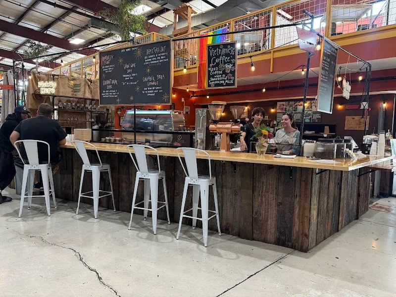 modern coffee shop counter with white bar stools and chalkboard menu displays., safai coffee shop, kentucky