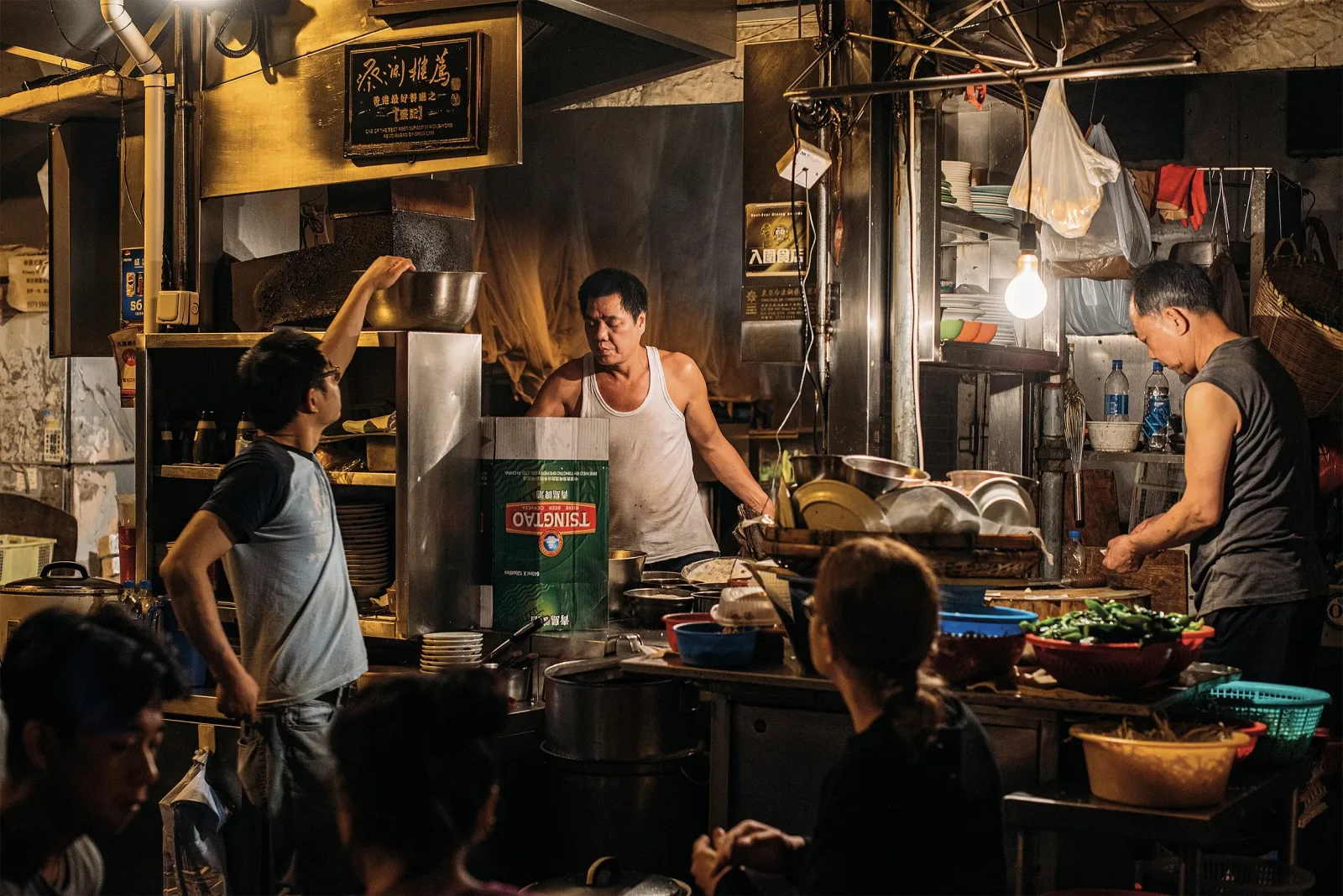 street food vendor cooking noodles for customers in crowded nighttime alley kitchen., seks, copenhagen