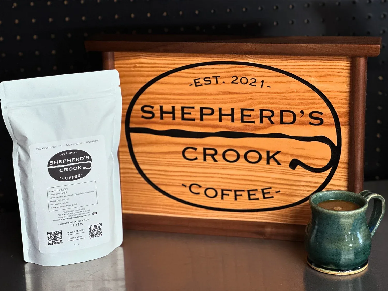 shepherd's crook coffee branded packaging, wooden sign, and ceramic mug display., shepherd’s crook coffee, springfield