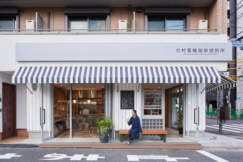 modern japanese coffee shop with striped awning and minimalist storefront design., shimura denki coffee roasters, tokyo