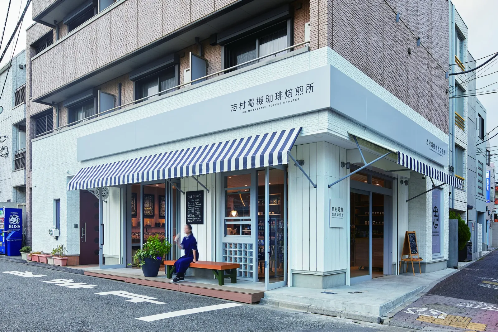 modern japanese coffee roastery with light blue awning and brick storefront., shimura denki coffee roasters, tokyo