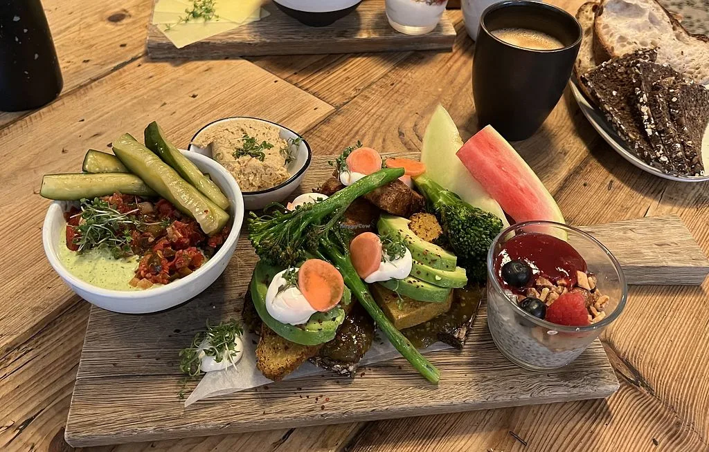 gourmet brunch spread with avocado toast, hummus, fresh vegetables, and berries on wooden table., sidecar, copenhagen