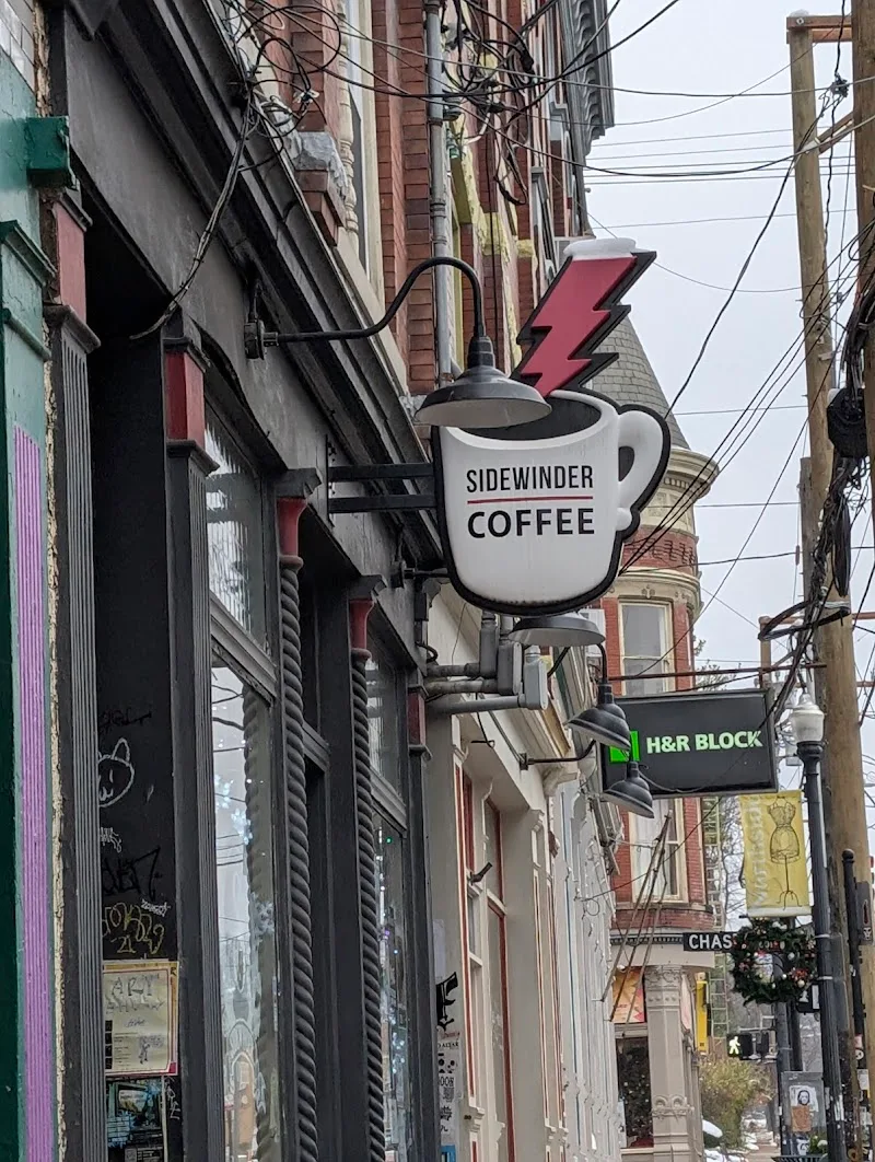 sidewinder coffee shop sign hanging above urban alleyway with tangled power lines., sidewinder coffee, cincinnati