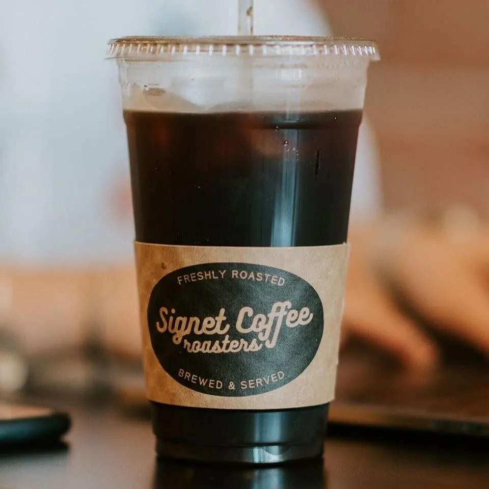 iced black coffee in clear cup with signet coffee roasters label and straw., signet coffee roasters, kansas