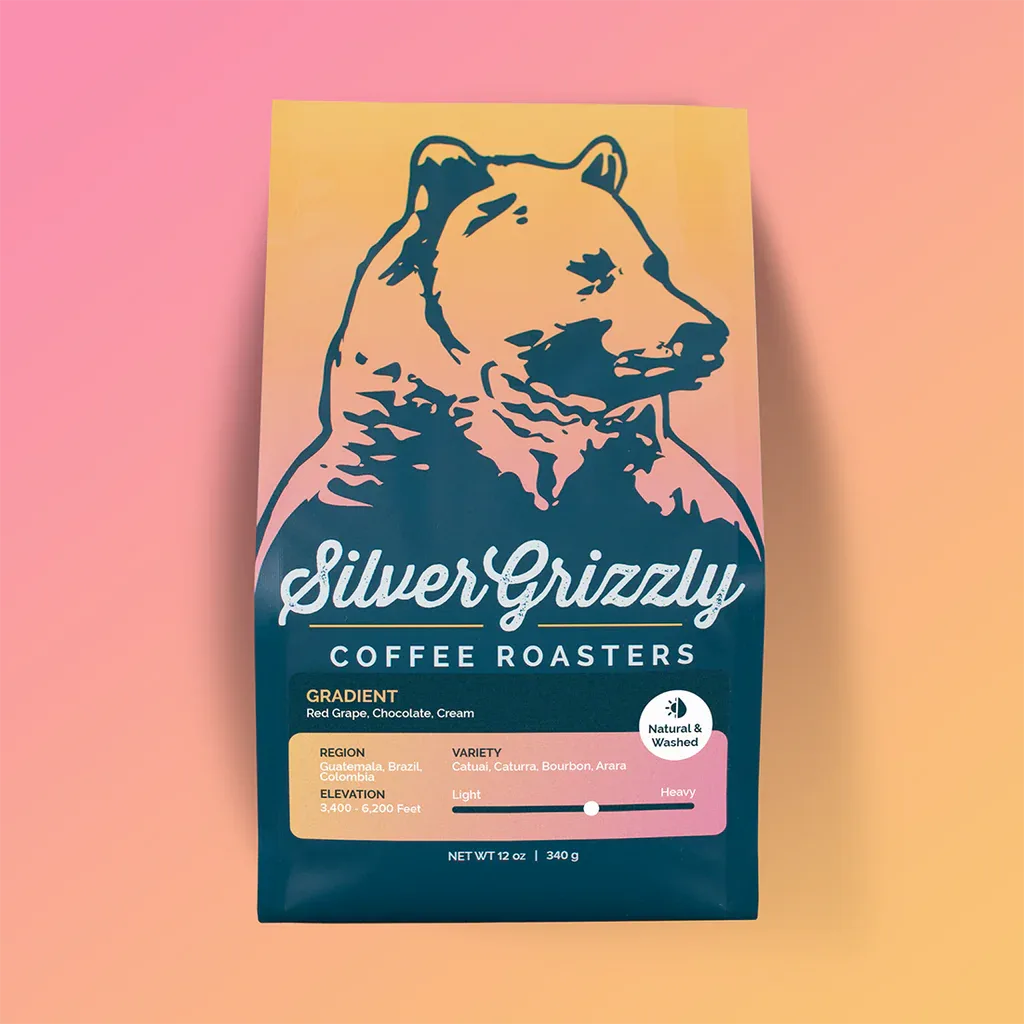 silver grizzly coffee roasters bag featuring bear illustration with gradient pink-to-yellow background., silver grizzly coffe