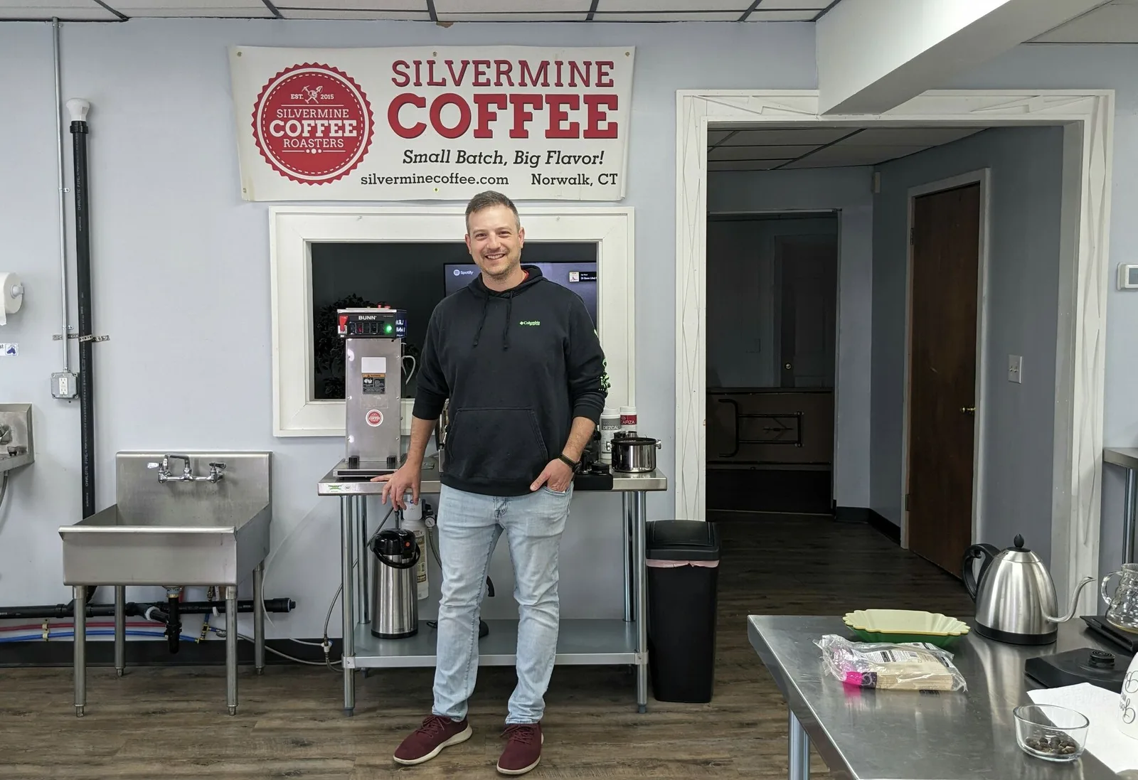man smiling in silvermine coffee roasters facility in norwalk, connecticut., silvermine coffee roasters, norwalk