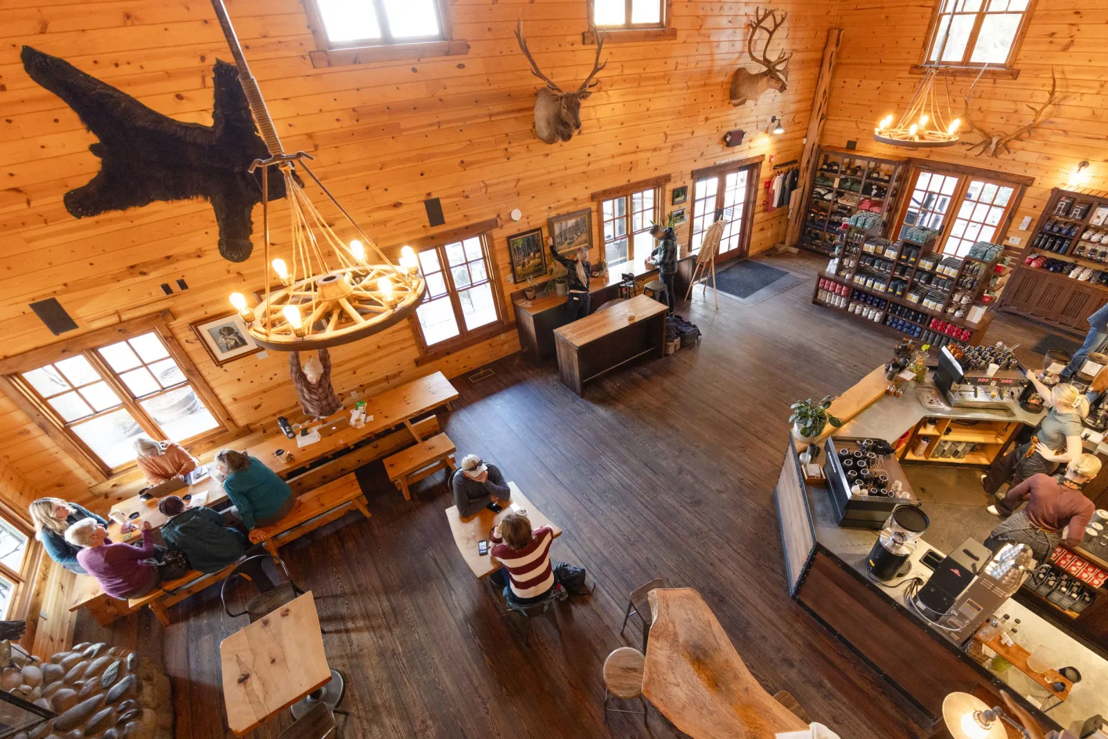 rustic lodge interior with taxidermy, gift shop, and visitors at wooden tables., sisters coffee company, sisters