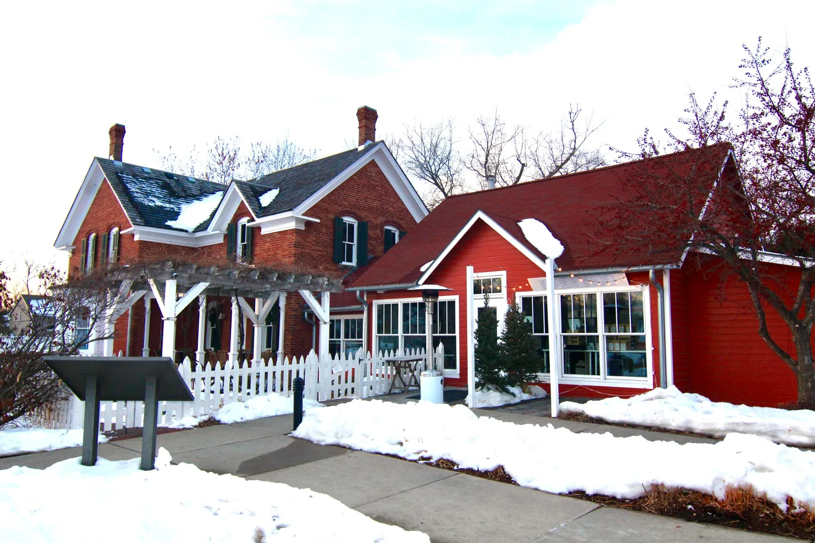 red brick farmhouse with white trim and additions covered in snow., smith coffee & cafe, eden prairie