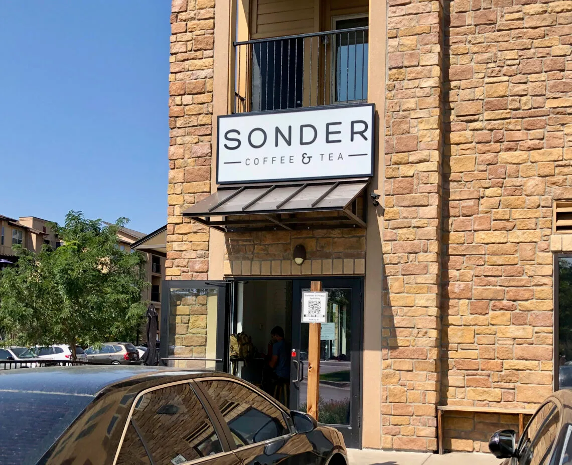 sonder coffee & tea storefront on brick building with metal awning and signage., sonder coffee & tea, aurora