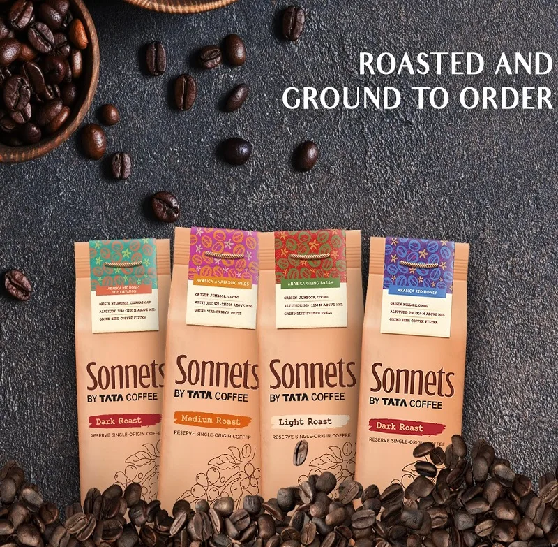 four sonnets coffee bags displayed with roasted beans on dark slate surface., sonnet coffee, orlando