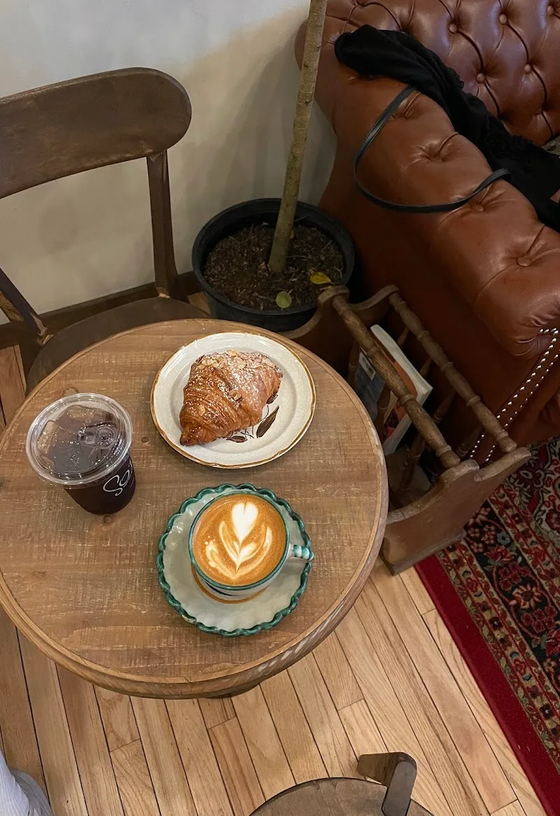 coffee with latte art, croissant, and cold drink on wooden table., sote coffee roasters, new york city
