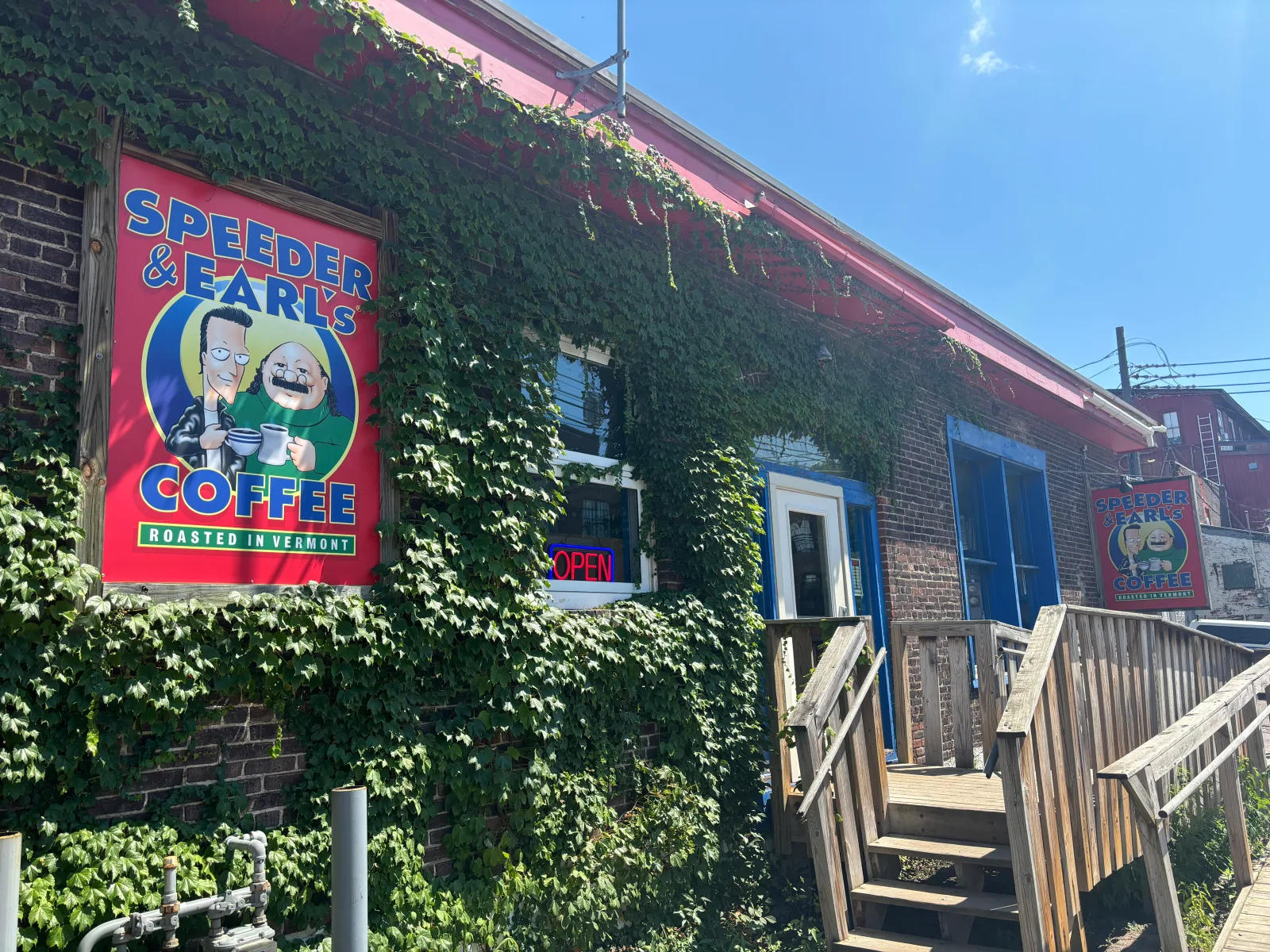 speeder and earls coffee shop storefront covered in ivy vines, vermont roasted., speeder & earl's coffee, vermont