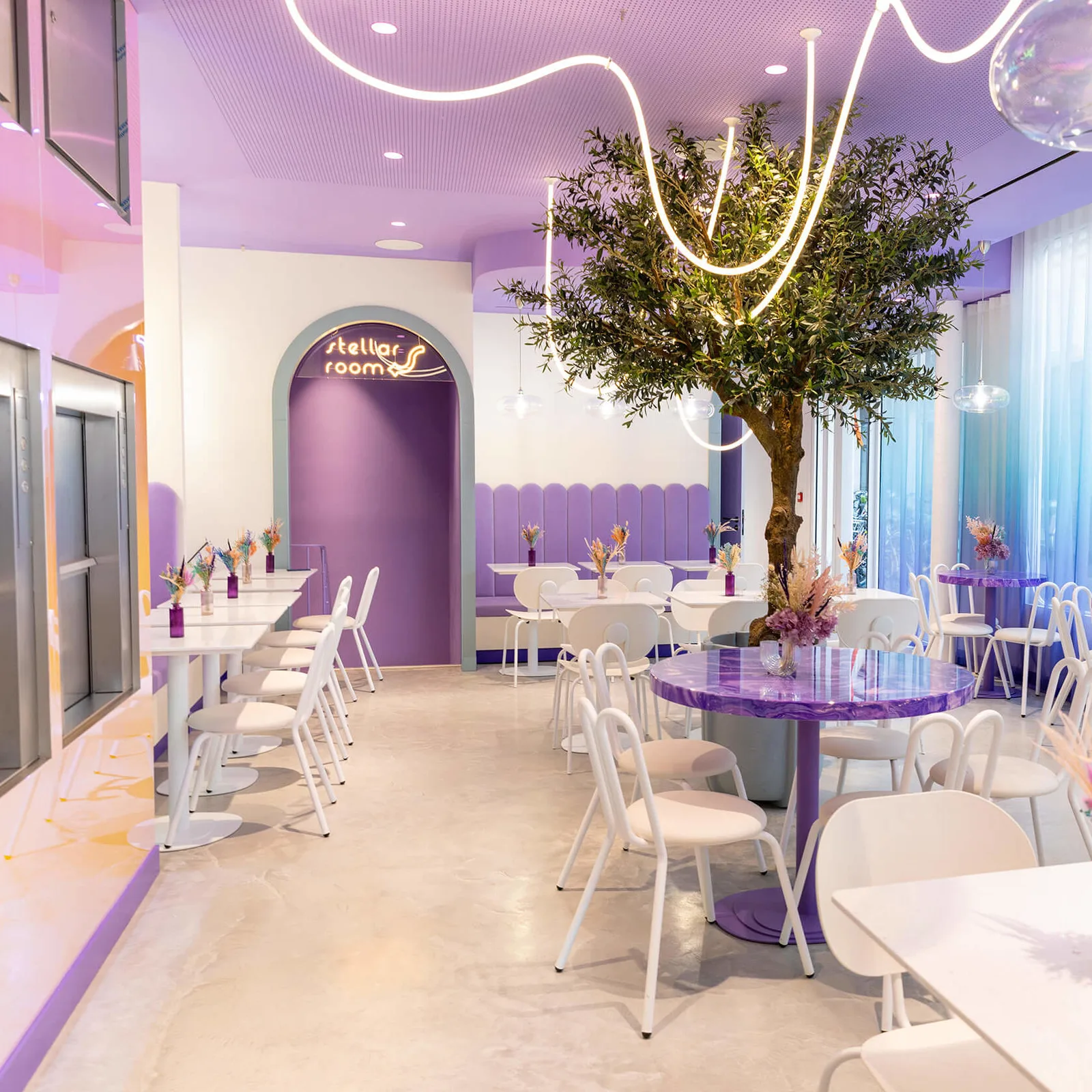 modern purple and white event space with neon lighting and elegant dining setup., stella mia, paris