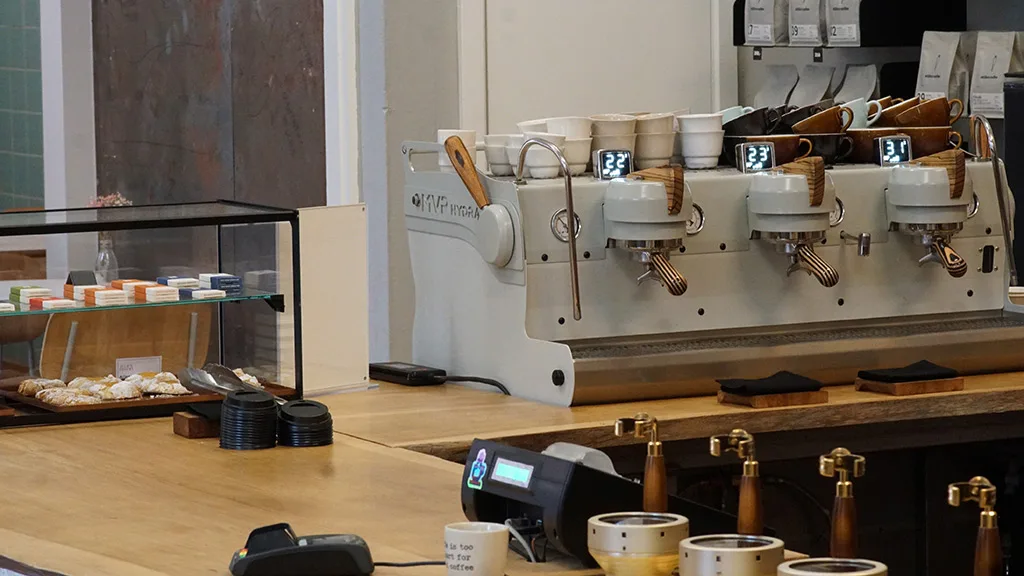 professional espresso machine with three group heads and wooden handles in modern café., stillers coffee, aarhus