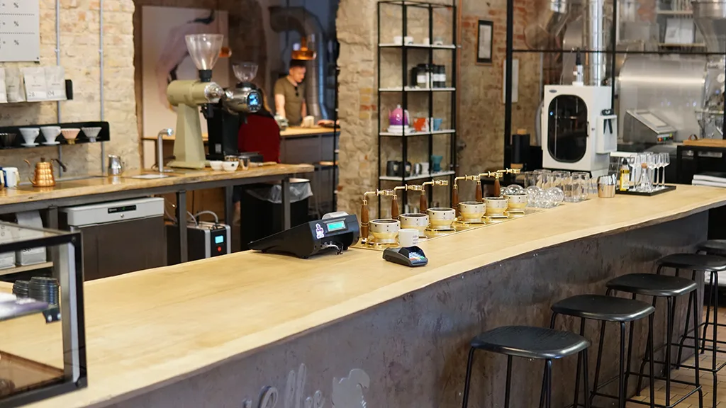 modern coffee shop interior with wooden counter, bar seating, and espresso equipment., stillers coffee, aarhus