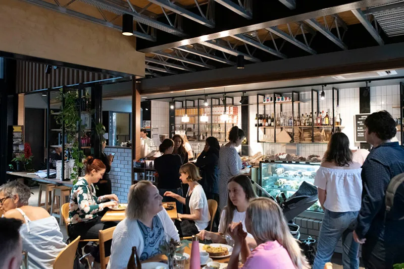 busy modern café with customers dining, exposed beam ceiling, and bar counter., streat cromwell cafe, collingwood