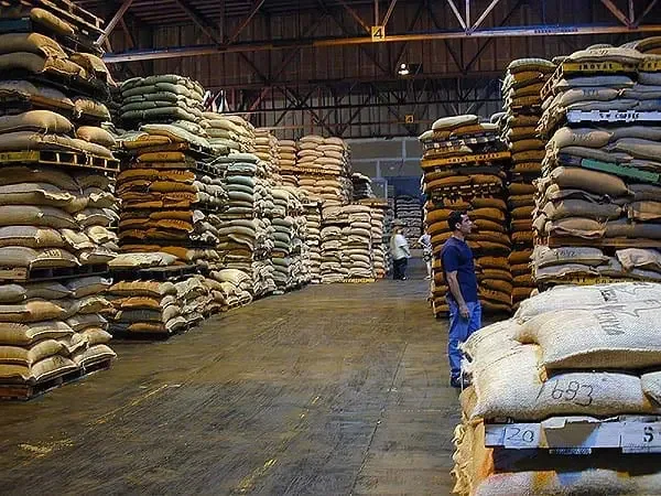 large warehouse stacked with sacks of grain or agricultural commodities., sweet maria's coffee warehouse, oakland