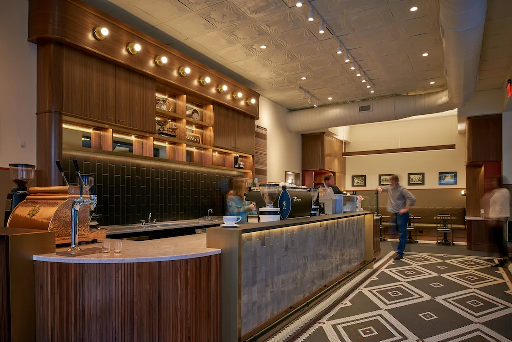 modern hotel lobby with wooden reception desk and geometric floor pattern., swing's coffee, washington