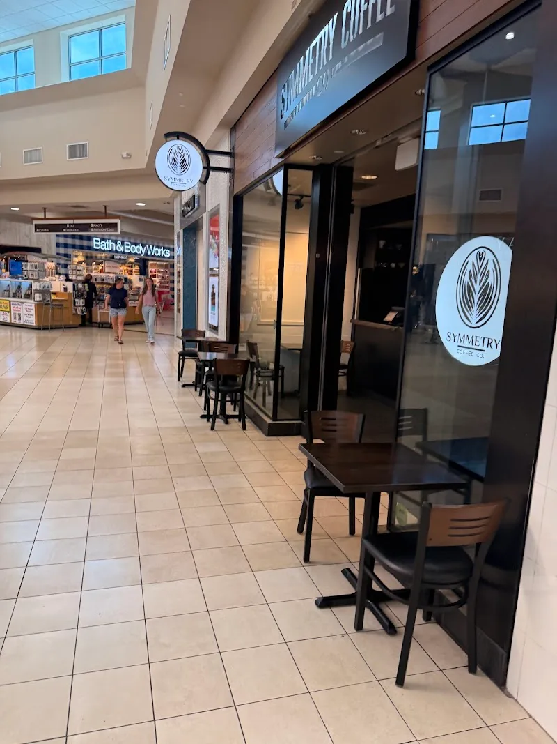 mall corridor with symmetry coffee shop and bath & body works storefront visible., symmetry coffee company, ocala