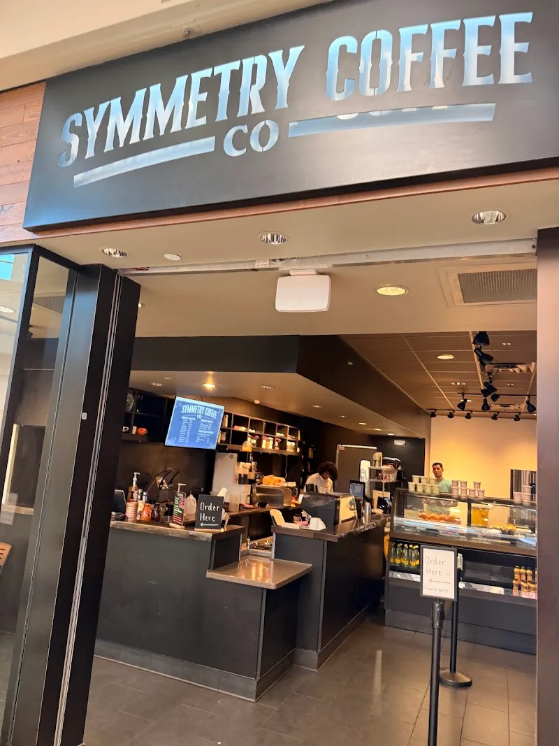 symmetry coffee co storefront with ordering counter and pastry display cases., symmetry coffee company, ocala