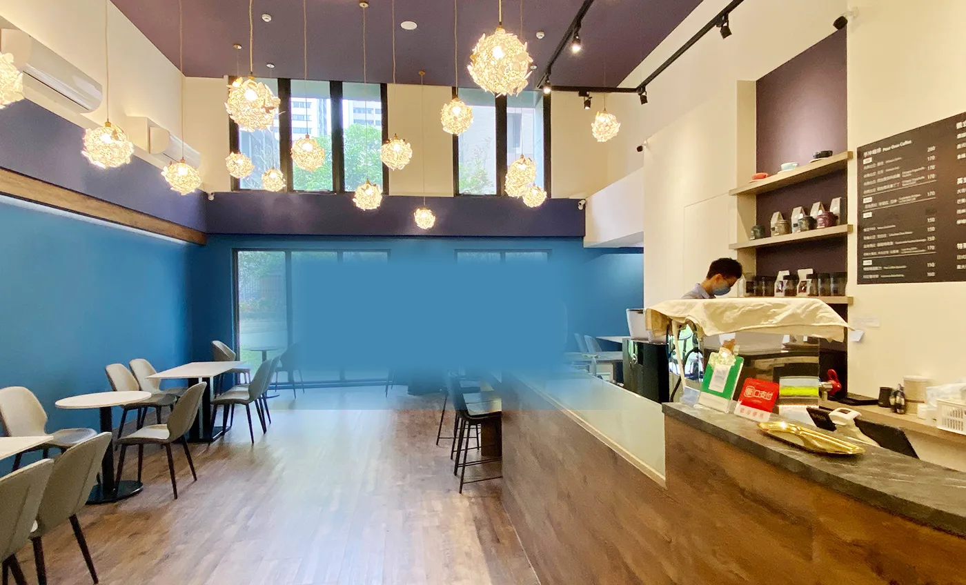 modern café interior with blue accent wall, pendant lighting, and service counter., 樸樹咖啡樹林店, taipei