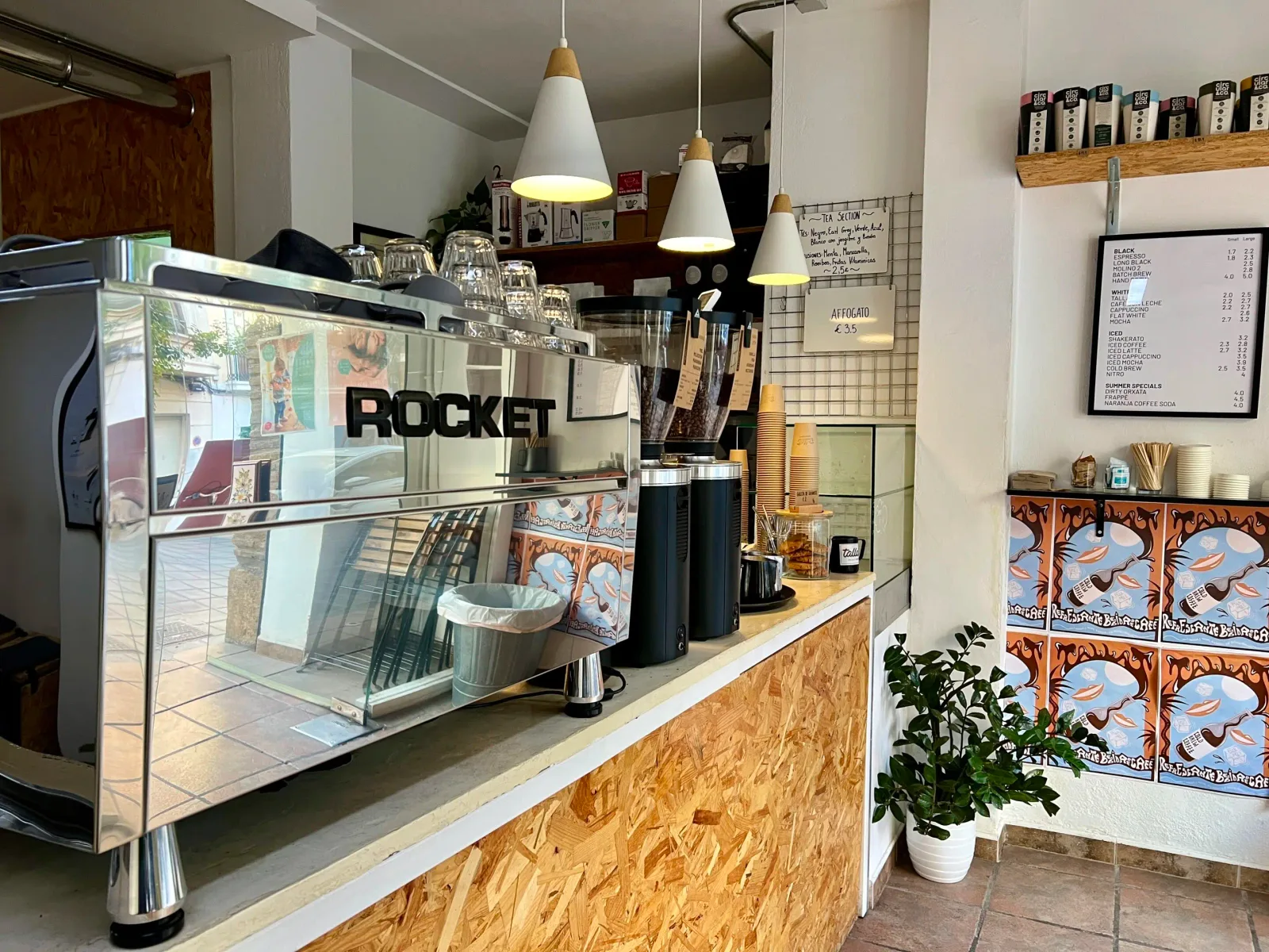 modern coffee shop counter with rocket espresso machine and pendant lighting., tallat coffee roasters, valència