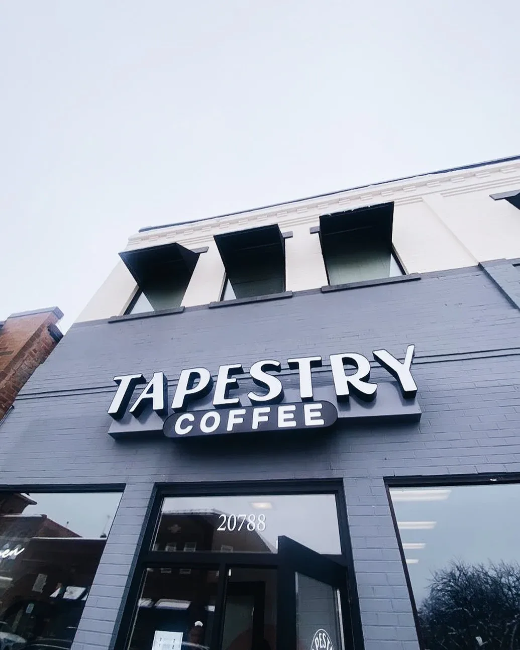 tapestry coffee storefront with address 20788, modern dark blue facade and large windows., tapestry coffee, lakeville