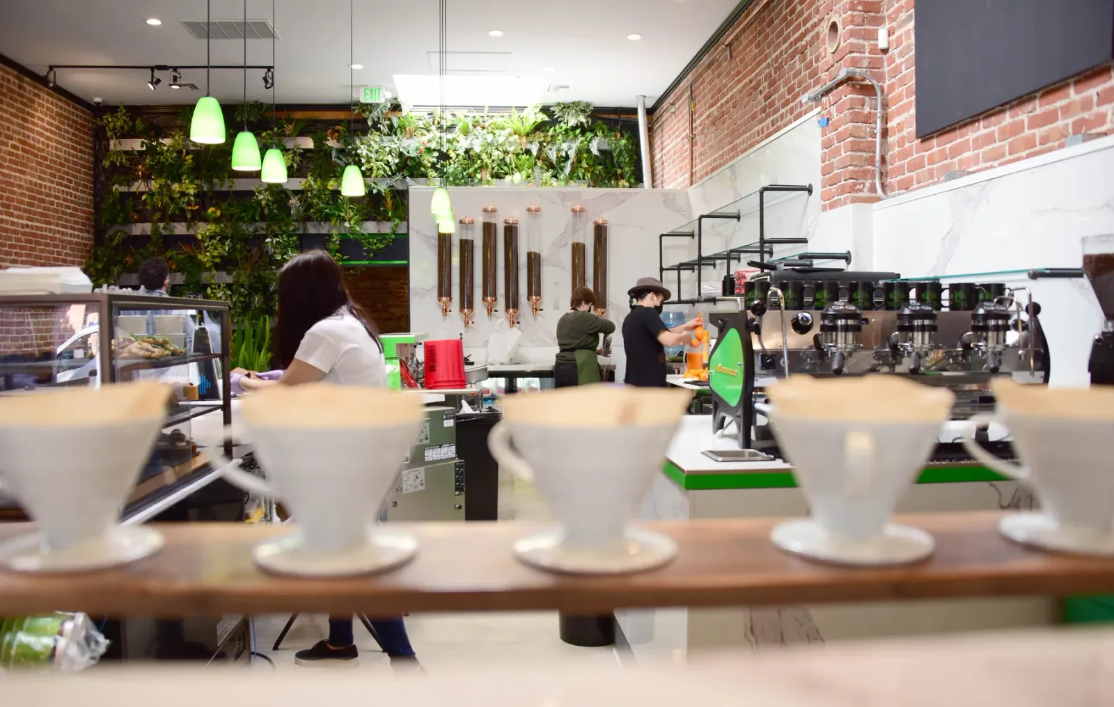 modern coffee shop interior with espresso machines, green plants, and brick walls., tellus coffee, walnut creek