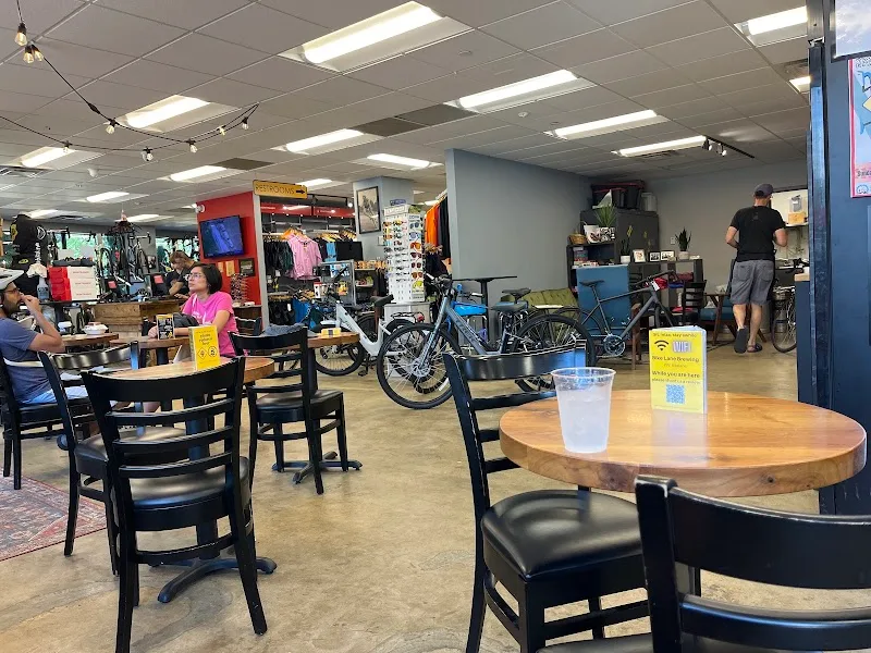 bicycle shop with café seating area, bikes, and customers inside., the bike lane bicycle shop and brewery, washington