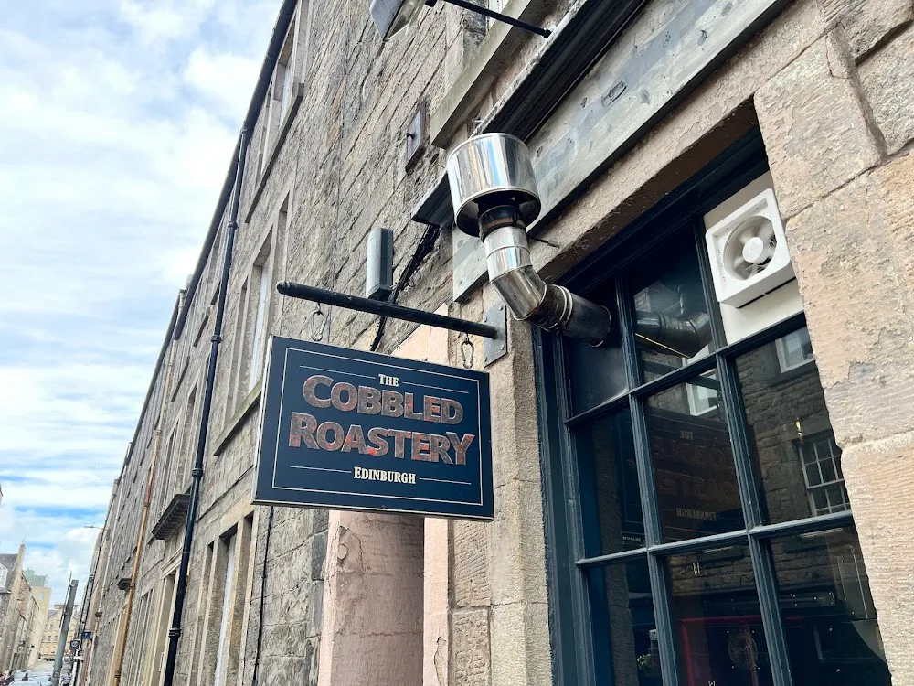 the cobbled roastery storefront in edinburgh with traditional stone building facade., the cobbled roastery, edinburgh
