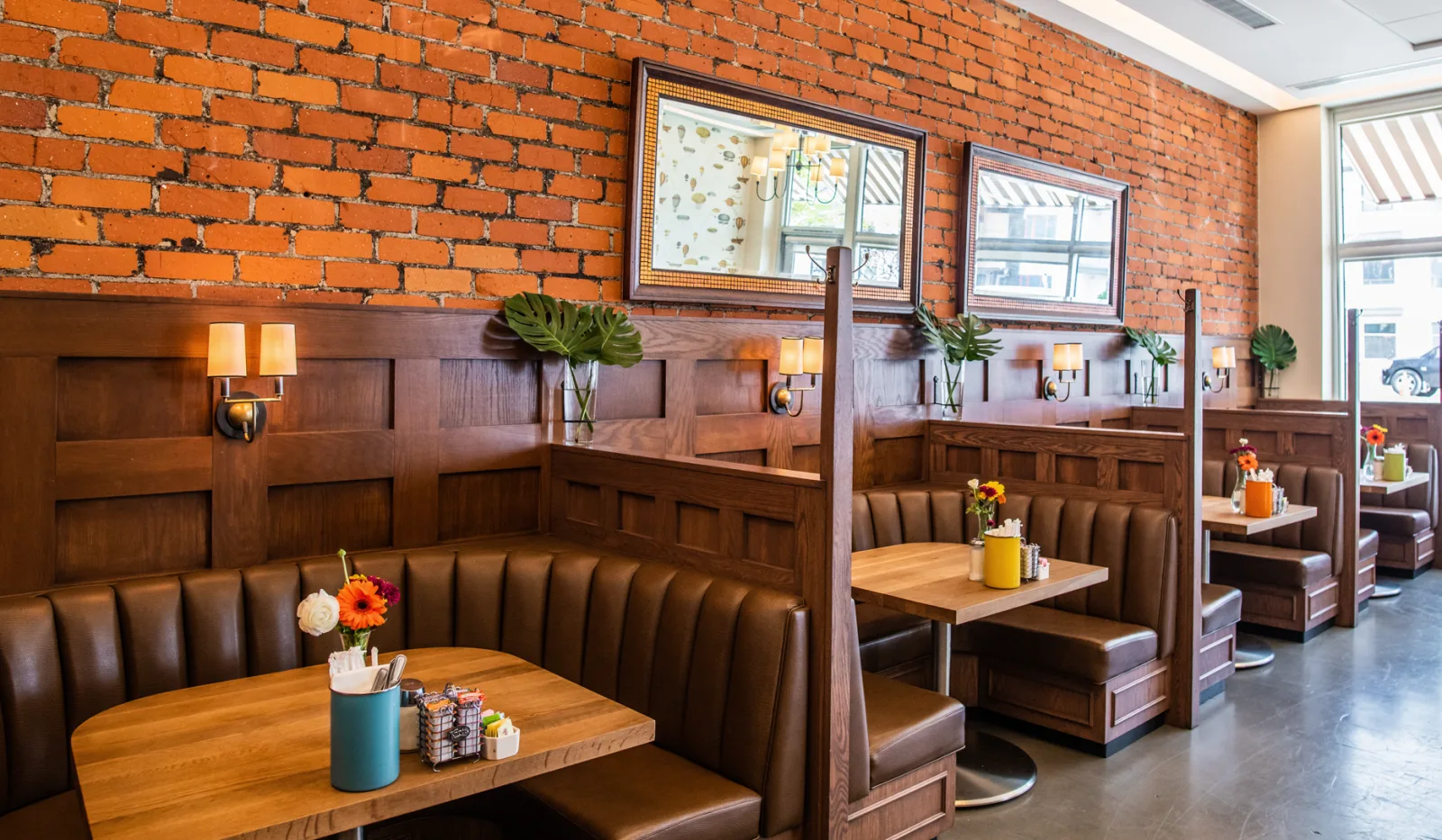 modern restaurant interior with booth seating, exposed brick walls, wooden paneling., the coffee company, los angeles