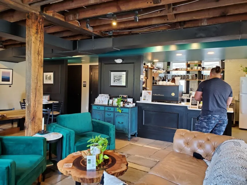 rustic office lobby with turquoise furniture and exposed wooden beams., the golden roast coffee house & roaster, knoxville